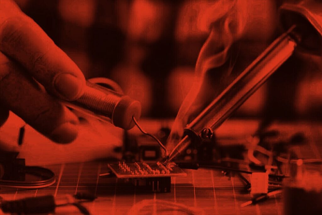 Soldering work on a circuit board in our repair workshop