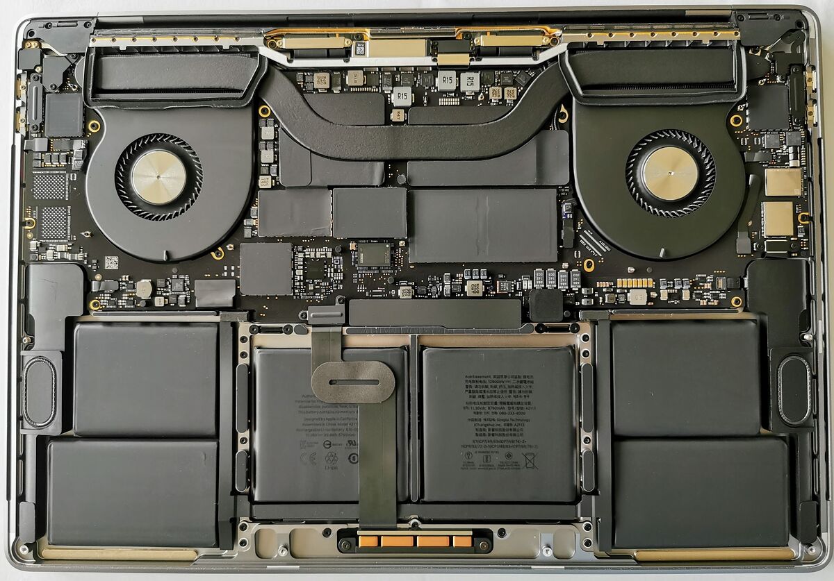 MacBook Pro 16 inch opened up, showing the logic board, both fans and the battery cells